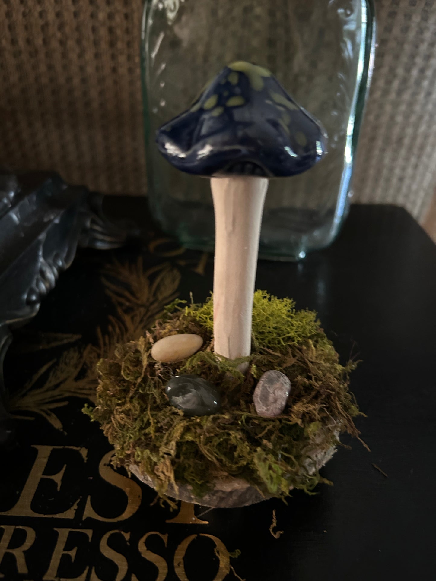Whimsical blue and green mushroom with moss and gemstones