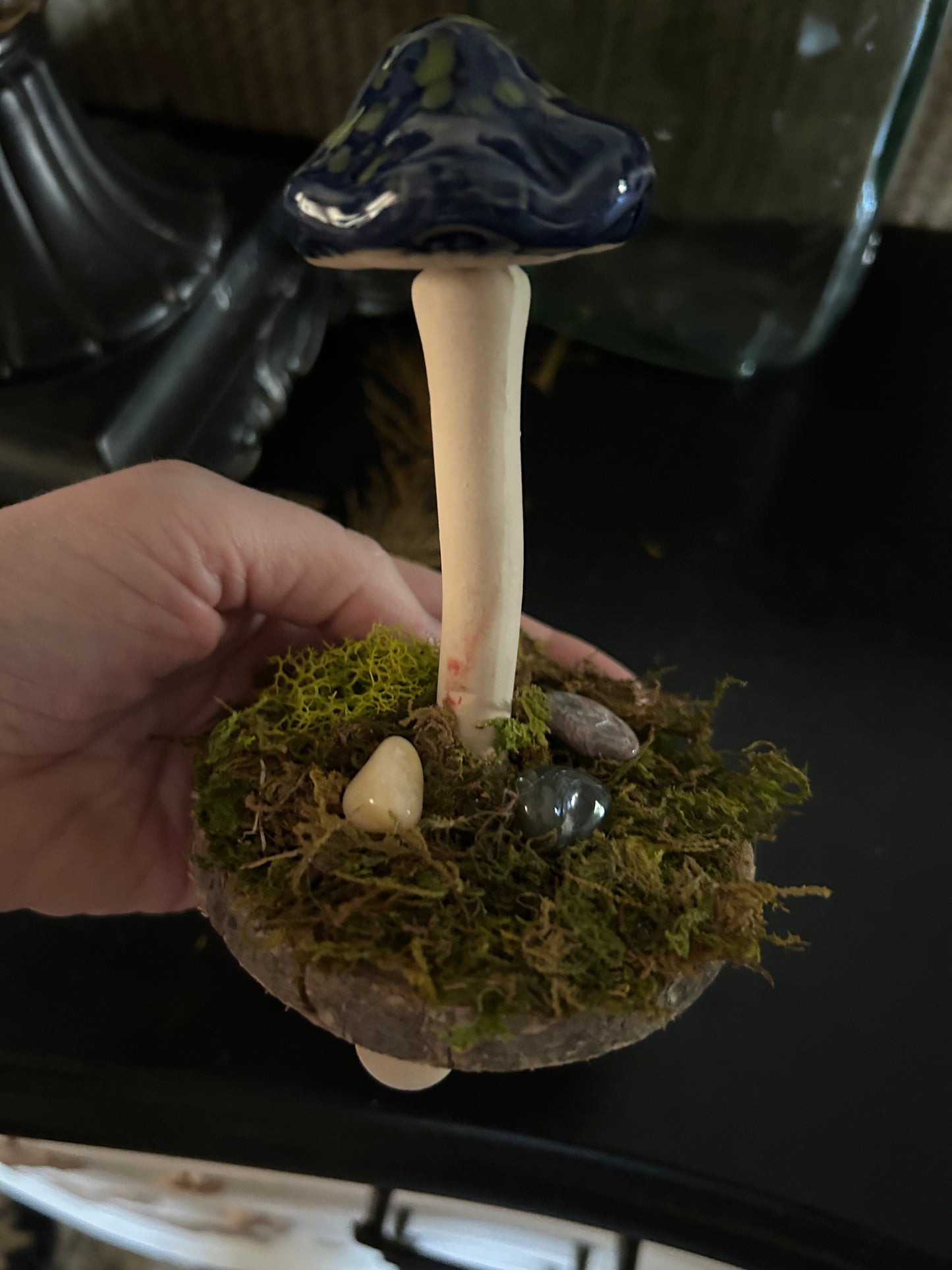Whimsical blue and green mushroom with moss and gemstones