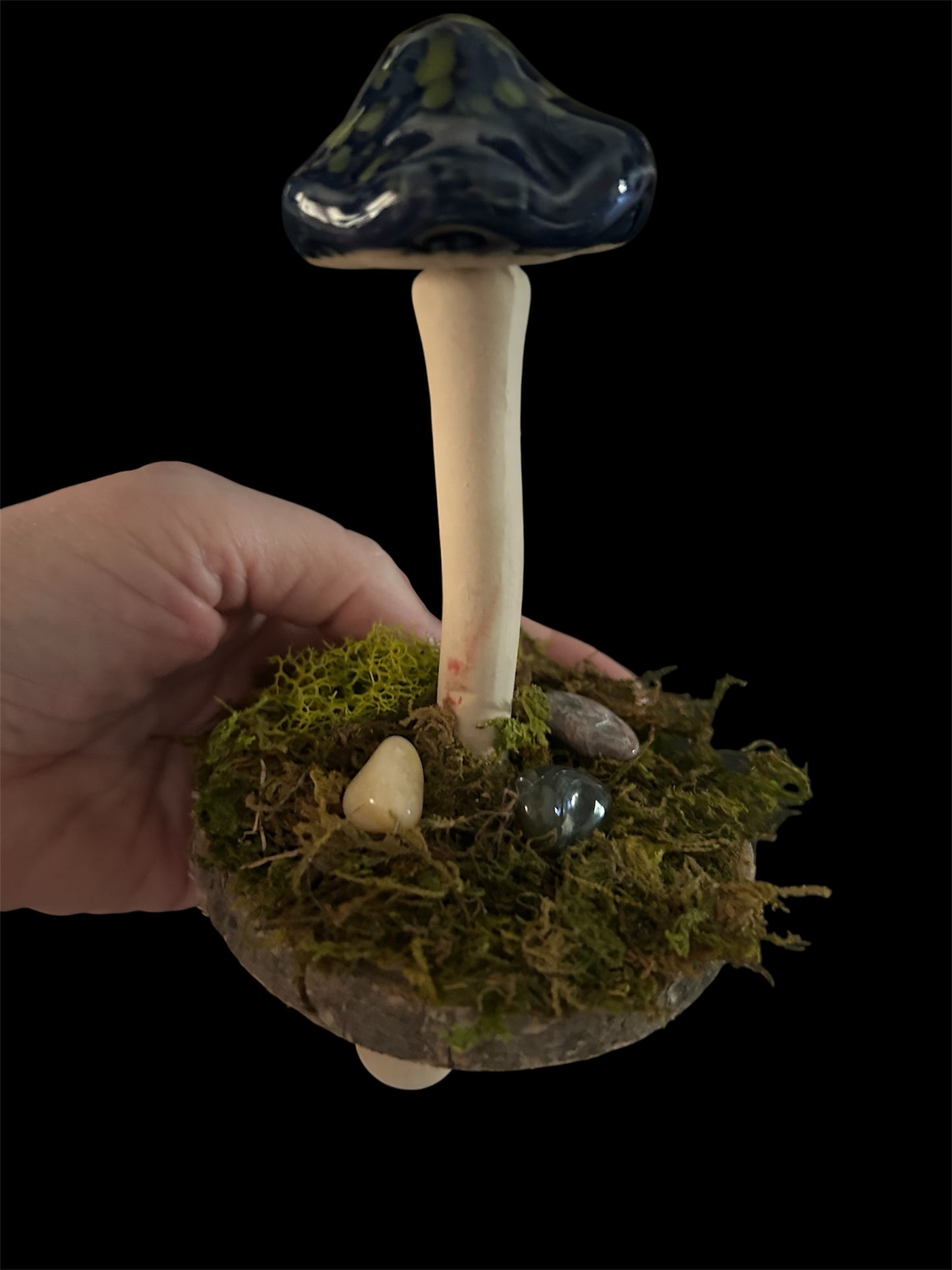 Whimsical blue and green mushroom with moss and gemstones