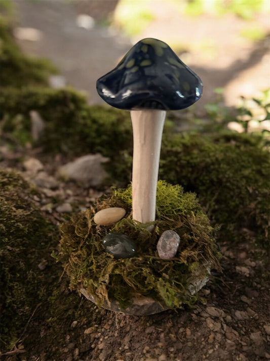 Whimsical blue and green mushroom with moss and gemstones