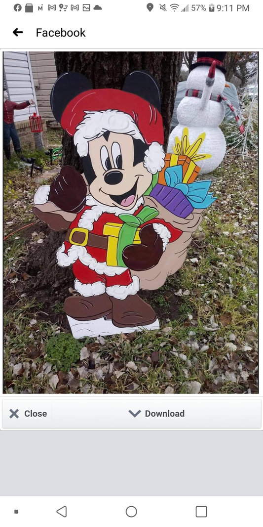 Mickey Mouse Santa carrying his pack of toys