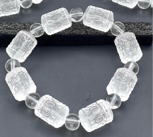 CLEAR QUARTZ MIXED SIZE CARVED BEAD STRETCH BRACELET