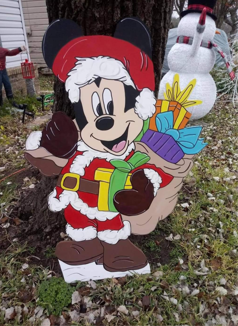 Mickey Mouse Santa carrying his pack of toys